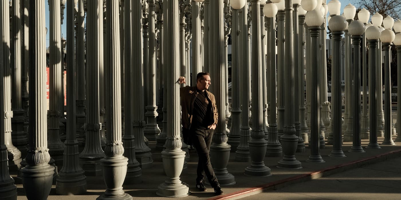 Garry Hall walking through the Urban Light lamp posts at LACMA