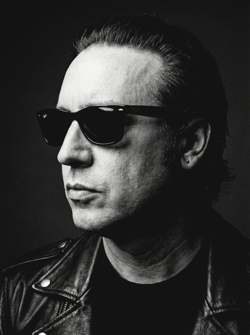 Black-and-white portrait of Garry Hall in sunglasses and a leather jacket
